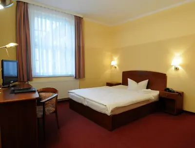 Ein Bett oder Betten in einem Zimmer der Unterkunft Hotel Döbelner Hof
