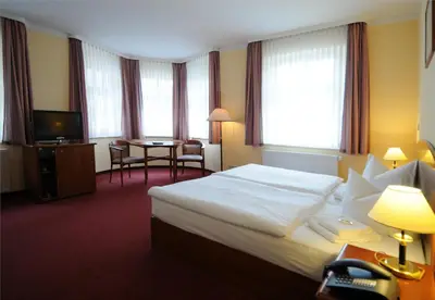 Ein Bett oder Betten in einem Zimmer der Unterkunft Hotel Döbelner Hof