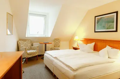 Ein Bett oder Betten in einem Zimmer der Unterkunft Eisenberger Hof