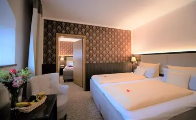Ein Bett oder Betten in einem Zimmer der Unterkunft Schlosshotel Klaffenbach