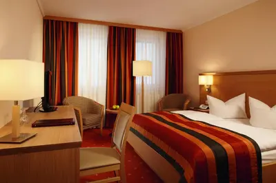 Ein Bett oder Betten in einem Zimmer der Unterkunft Parkhotel Neustadt