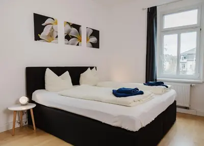 Ein Bett oder Betten in einem Zimmer der Unterkunft Apartmenthaus Sternstraße 6