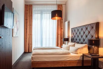 Ein Bett oder Betten in einem Zimmer der Unterkunft Aparthotel Neumarkt