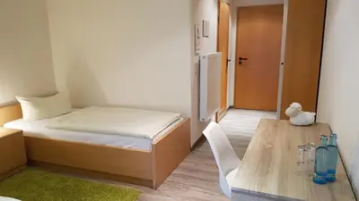 Ein Bett oder Betten in einem Zimmer der Unterkunft Schneiderlein Hotel