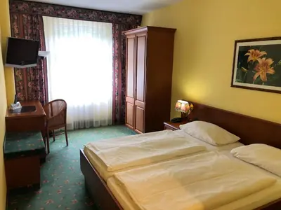Ein Bett oder Betten in einem Zimmer der Unterkunft Brandiser Parkhotel