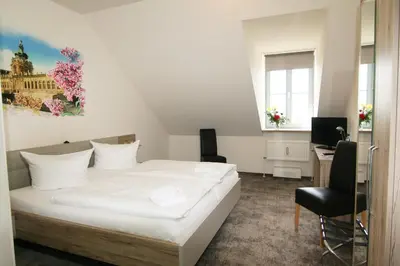 Ein Bett oder Betten in einem Zimmer der Unterkunft Hotel am Waldschlösschen - Brauhaus