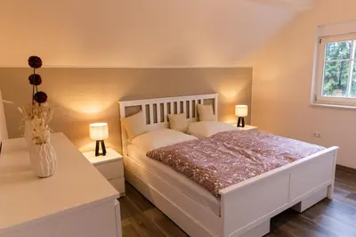 Ein Bett oder Betten in einem Zimmer der Unterkunft Ferienwohnung Schwalbennest-Großkoschen