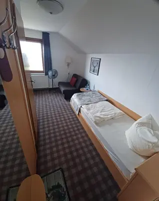 Ein Bett oder Betten in einem Zimmer der Unterkunft Berghotel Augustusberg