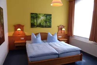 Ein Bett oder Betten in einem Zimmer der Unterkunft Hotel Seiffener Hof***