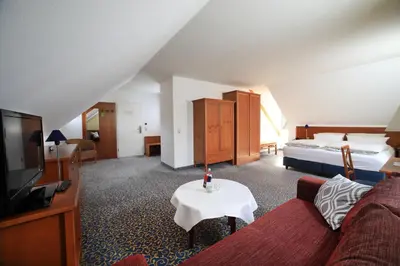 Ein Bett oder Betten in einem Zimmer der Unterkunft Landidyll Hotel Erbgericht Tautewalde