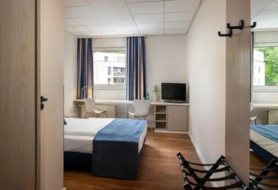 Ein Bett oder Betten in einem Zimmer der Unterkunft NOVALIS Hotel Dresden by AURUM