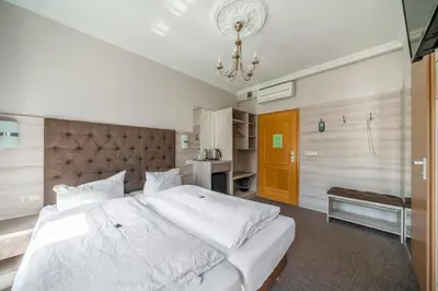 Ein Bett oder Betten in einem Zimmer der Unterkunft Hotel Villa am Waldschlösschen