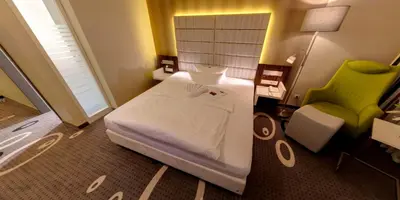 Ein Bett oder Betten in einem Zimmer der Unterkunft Business-Hotel Artes