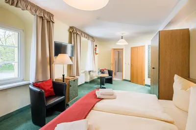 Ein Bett oder Betten in einem Zimmer der Unterkunft Landhaus Purschenstein