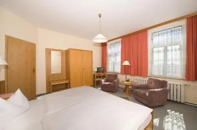 Ein Bett oder Betten in einem Zimmer der Unterkunft Panoramahotel Wolfsberg