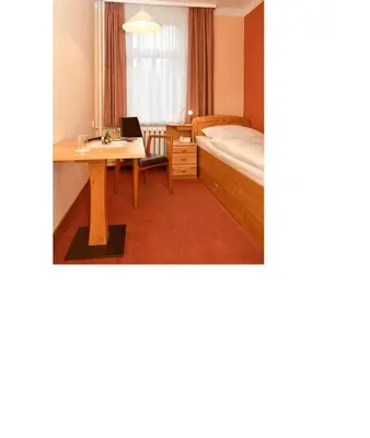 Ein Bett oder Betten in einem Zimmer der Unterkunft Panoramahotel Wolfsberg