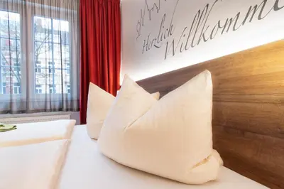 Ein Bett oder Betten in einem Zimmer der Unterkunft Hotel Wettiner Hof