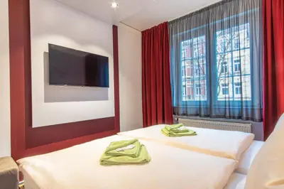 Ein Bett oder Betten in einem Zimmer der Unterkunft Hotel Wettiner Hof