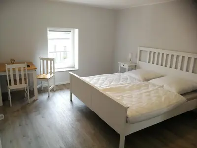Ein Bett oder Betten in einem Zimmer der Unterkunft Pension Schlossblick Thallwitz