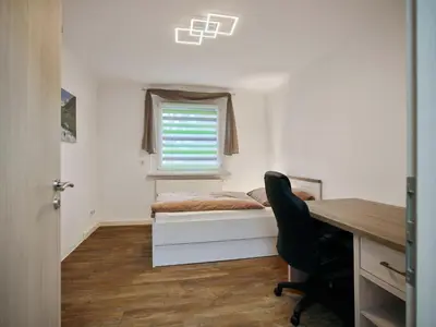 Ein Bett oder Betten in einem Zimmer der Unterkunft Gäste- und Ferienwohnung in der Sportstadt Riesa