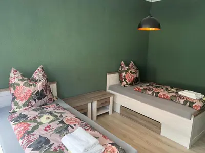 Ein Bett oder Betten in einem Zimmer der Unterkunft Gästehaus Graupner-Hainichen