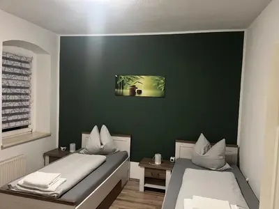 Ein Bett oder Betten in einem Zimmer der Unterkunft Gästehaus Graupner-Hainichen