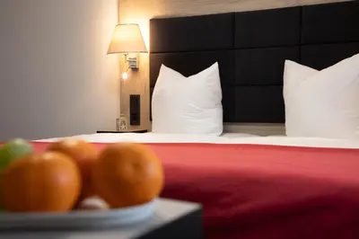 Ein Bett oder Betten in einem Zimmer der Unterkunft Hotel zur Kulturweberei