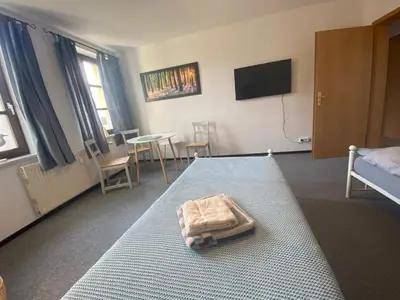Ein Bett oder Betten in einem Zimmer der Unterkunft Fewo Sachsenhöhe