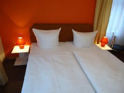 Ein Bett oder Betten in einem Zimmer der Unterkunft Pension Dresdener Panorama