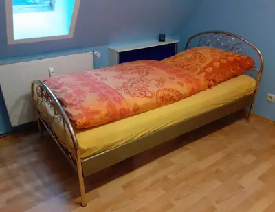 Ein Bett oder Betten in einem Zimmer der Unterkunft Schöne und ruhige Ferienwohnung in Ottendorf