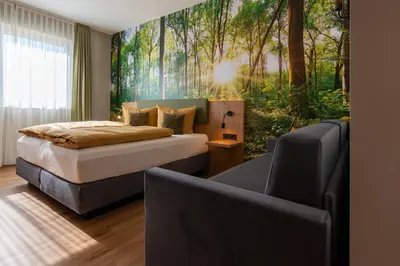 Ein Bett oder Betten in einem Zimmer der Unterkunft Hotel am Sonnenlandpark