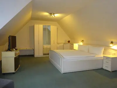 Ein Bett oder Betten in einem Zimmer der Unterkunft Ferienwohnung Pension Sigwarth