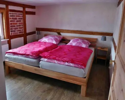 Ein Bett oder Betten in einem Zimmer der Unterkunft FeWo Dorn OG Haus Sandsteinliebe