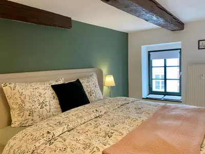 Ein Bett oder Betten in einem Zimmer der Unterkunft Am Engelserker - Ferienwohnungen in der Altstadt