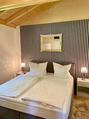 Ein Bett oder Betten in einem Zimmer der Unterkunft Ferienhaus Rosengarten