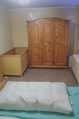 Ein Bett oder Betten in einem Zimmer der Unterkunft Pension Muldental Großbothen Wohnung 1