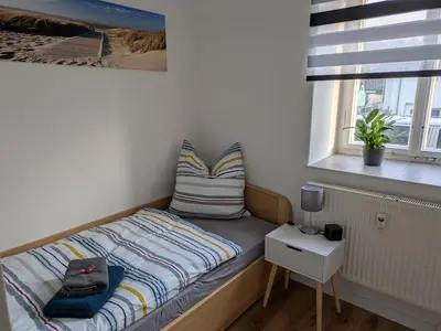 Ein Bett oder Betten in einem Zimmer der Unterkunft Monteur Ferienwohnungen OT Kleinwaltersdorf mit Außensitzecke und Grill