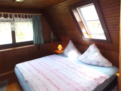 Ein Bett oder Betten in einem Zimmer der Unterkunft Ferienhaus Zum Gründel
